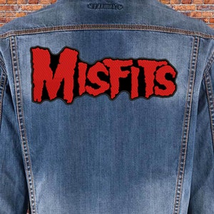 May include: A blue denim jacket with a red and black "Misfits" patch sewn on the back.