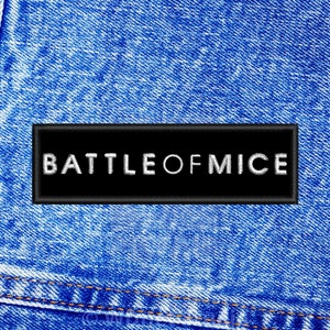 May include: A black patch with white text that reads "BATTLE OF MICE" sewn onto a blue denim fabric.