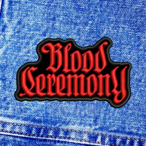 May include: Red embroidered patch with the words "Blood Ceremony" in a gothic font on a black background.
