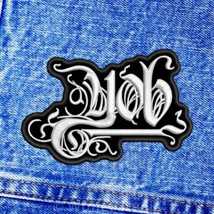 May include: A black and white embroidered patch with the word "Job" in a stylized font. The patch is sewn onto a blue denim jacket.