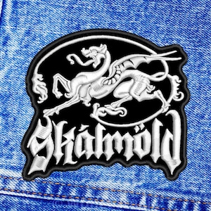 May include: A black and white embroidered patch with a white dragon and the word "Skald" in white lettering.