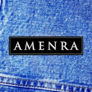 May include: A black patch with white text that reads "AMENRA" sewn onto a blue denim background.