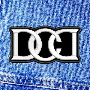 May include: White embroidered "DC" logo patch on a blue denim background.