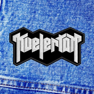 May include: A black and white embroidered patch with the word "Fuelertot" in a bold, stylised font.