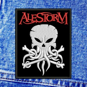 May include: Black embroidered patch with a white skull and crossed bones. The skull has tentacles and the text "ALESTORM" is in red above the skull.