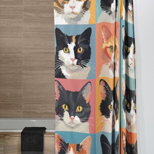 May include: A shower curtain with a colourful pop art design featuring multiple images of cats with different coloured fur. The cats are looking directly at the viewer.