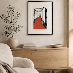 May include: A framed wall art print featuring a black and white ink-style illustration of a long corridor with a vibrant red floor. The artwork is enclosed in a thin black frame with a white mat border, displayed on a neutral-toned wall.