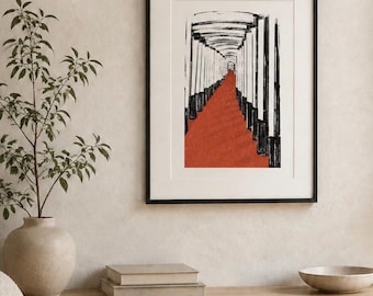 May include: A framed wall art print featuring a black and white ink-style illustration of a long corridor lined with vertical pillars, with a vibrant red path extending through the center, enclosed in a simple black frame with a white mat border.