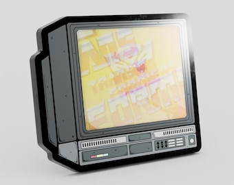 May include: A dark gray enamel pin shaped like a vintage television set. The screen displays a yellow and white graphic with stylized text. The frame features detailed black outlines, control buttons, and a small rectangular accent in red and blue.