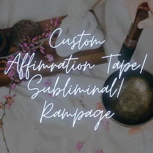 May include: A person holds a bronze singing bowl with a geometric pattern. The image features a wooden tray with a small statue, prayer beads, and the text "Custom Affirmation Tape/ Subliminal/ Rampage". Pink flowers are scattered.