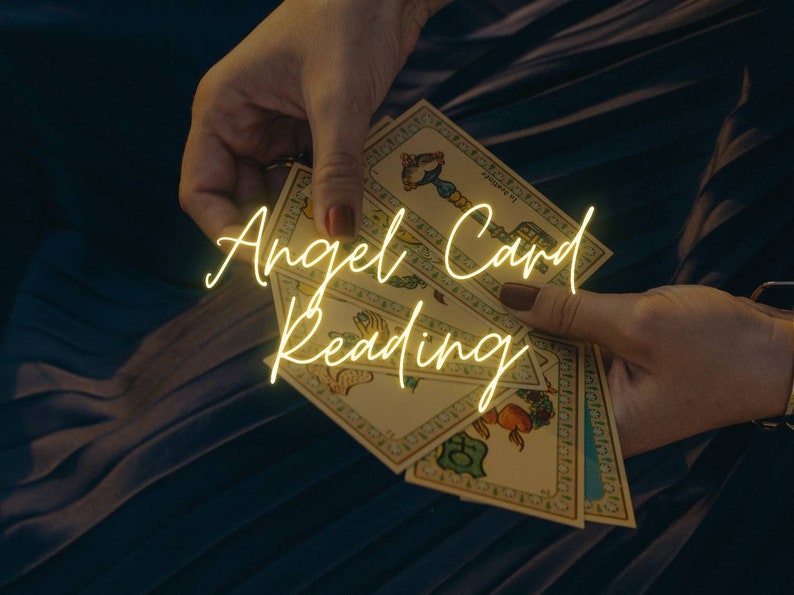 May include: A person's hands holding a stack of angel cards, with the text "Angel Card Reading" in yellow neon lettering.