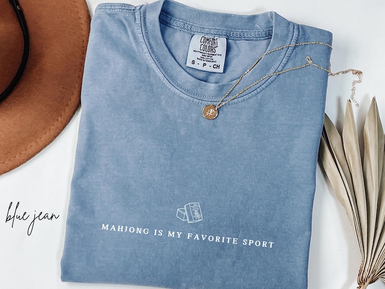 Show your love for the game with our “Mahjong Is My Favorite Sport” shirt! Perfect for Filipina moms, dads, and mahjong enthusiasts, this comfy Comfort Colors® tee is great for game nights or casual wear. A fun gift for players of American or traditional mahjong — stylish and spirited!