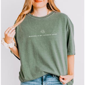 Show your love for the game with our “Mahjong Is My Favorite Sport” shirt! Perfect for Filipina moms, dads, and mahjong enthusiasts, this comfy Comfort Colors® tee is great for game nights or casual wear. A fun gift for players of American or traditional mahjong — stylish and spirited!
