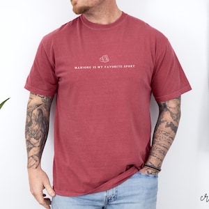 Show your love for the game with our “Mahjong Is My Favorite Sport” shirt! Perfect for Filipina moms, dads, and mahjong enthusiasts, this comfy Comfort Colors® tee is great for game nights or casual wear. A fun gift for players of American or traditional mahjong — stylish and spirited!