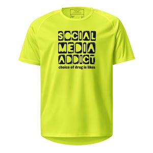 May include: A neon yellow short-sleeved t-shirt with the text "SOCIAL MEDIA ADDICT" in black block letters. Below the text is the phrase "choice of drug is likes". The shirt has a crew neck and a tag at the top.