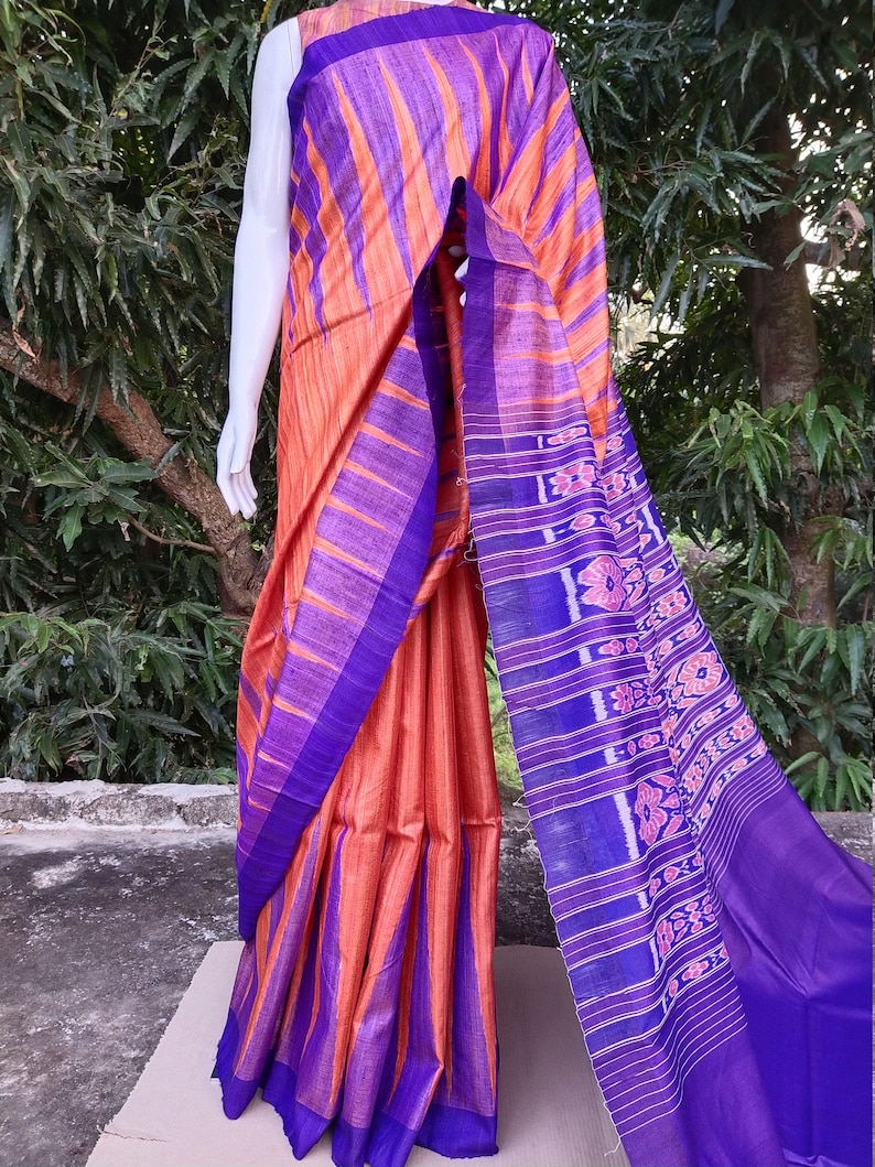 This saree comes with a blouse piece in royal blue. Handwoven orange and royal blue tussar ghicha saree with sambalpuri design in palla