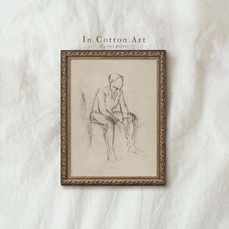 The image is a framed drawing of a man sitting in a chair, which appears to be a sketch or drawing.