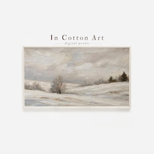 May include: A framed landscape print featuring a winter scene with snow-covered fields and trees under a cloudy sky. The artwork is in muted tones of white, gray, and beige, with the text "In Cotton Art - digital prints" at the top.