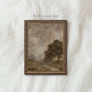 May include: Framed landscape art print featuring a serene countryside scene with a tree, a river, and a cloudy sky. The artwork is in muted tones of brown, gray, and beige, with the text "In Cotton Art digital prints" in the upper center.