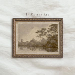 May include: A framed sepia-toned landscape print featuring a serene lake scene with trees and their reflections. The artwork is in a decorative gold frame. The text "In Cotton Art digital prints" is visible.
