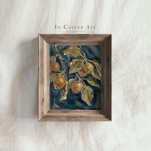 May include: A framed wall art print featuring a painting of golden-brown fruit hanging from branches with green leaves against a dark blue background. The text In Cotton Art digital prints is visible above the wooden frame.
