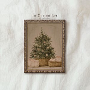May include: A framed digital print depicting a Christmas tree adorned with baubles and presents. The tree is in a wicker basket, with two wrapped gifts at the base. The frame has a gold-coloured ornate design. The text "In Cotton Art digital prints" is at the top.