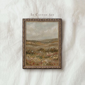 May include: A framed landscape painting with a rustic gold frame. The artwork depicts a field of wildflowers and rolling hills under a cloudy sky. The text "In Cotton Art digital prints" is at the top.
