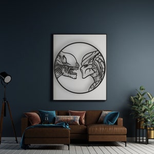May include: A black and white illustration of an alien and a predator facing each other inside a circle. The image is framed and hanging on a wall above a brown leather sofa.