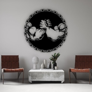 May include: Black and white silhouette of two muscular arms engaged in an arm wrestling match, set against a background of a chain link circle.