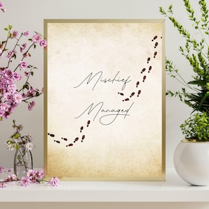 Peut inclure: Une impression beige avec le texte "Mischief Managed" en écriture cursive noire. L'impression présente une traînée d'empreintes rouges en forme de ligne courbe.