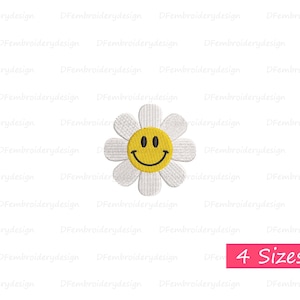 May include: White daisy flower with a yellow smiley face in the center. The flower has six petals and is embroidered. The image is on a white background.