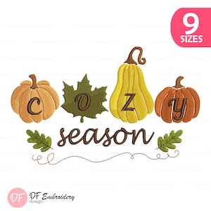 May include: An embroidered design with the words "COZY season" and autumn-themed elements, including pumpkins and a leaf. The design includes the text "9 SIZES" in a pink box and the "DF Embroidery design" logo.