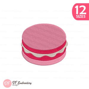 May include: A pink embroidered design of a macaron with white filling. The design includes the text "12 SIZES" in a pink rounded rectangle. The logo "DF Embroidery design" is in the bottom left corner.