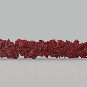 May include: A decorative red floral garland with roses and leaves. The garland is made of a smooth, sculpted material and is perfect for adding a touch of elegance to any home decor.