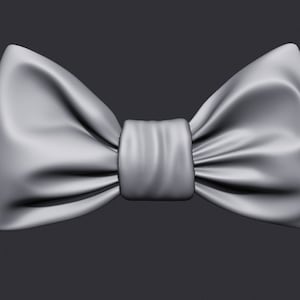 Può includere: Un papillon grigio in tessuto con una texture liscia e setosa.