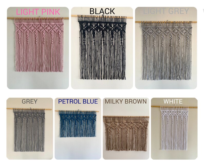 May include: A collection of eight macrame wall hangings in various colors, including light pink, black, light grey, grey, petrol blue, milky brown, and white. Each hanging features a geometric pattern with a wooden dowel at the top.