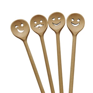 May include: Set of four wooden spoons with different smiley faces carved into the top. The spoons are brown and have a natural wood finish.