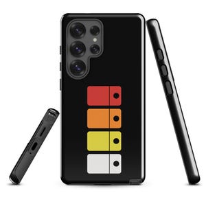 May include: Black phone case with a colorful retro design. The case features a stacked pattern of red, orange, yellow, and white rectangles, each with a black dot. A black phone and a black phone case are also in the image.
