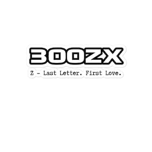 Op de afbeelding: Een witte sticker met de zwarte tekst "300ZX" in een vetgedrukte, schreefloze lettertype. Daaronder staat de zin "Z - Last Letter. First Love." in een kleiner, schreefloos lettertype.