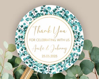May include: Round sticker with a gold border and text that reads "Thank You FOR CELEBRATING WITH US Aoife & Johnny 25.05.2025". The sticker has a white background with a teal and green eucalyptus leaf design.