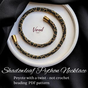 May include: A handcrafted Shadowleaf Python necklace with a beaded design in black, gold, and green. The necklace is displayed on a white circular surface. The text "Shadowleaf Python Necklace" and "Peyote with a twist - not crochet beading PDF pattern" are visible.