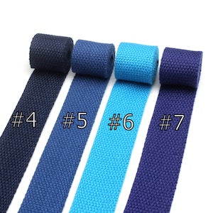 May include: Four rolls of cotton webbing in different colors: navy blue, dark blue, turquoise, and a darker shade of navy blue. The rolls are labeled #4, #5, #6, and #7.