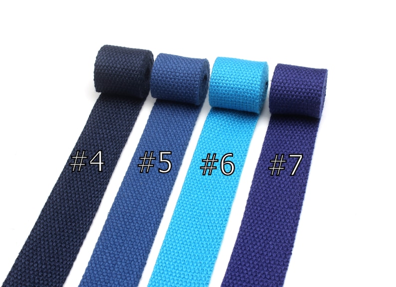 May include: Four rolls of cotton webbing in different colors: navy blue, dark blue, turquoise, and a darker shade of navy blue. The rolls are labeled #4, #5, #6, and #7.