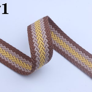 May include: Brown and yellow woven ribbon with a chevron pattern. #1