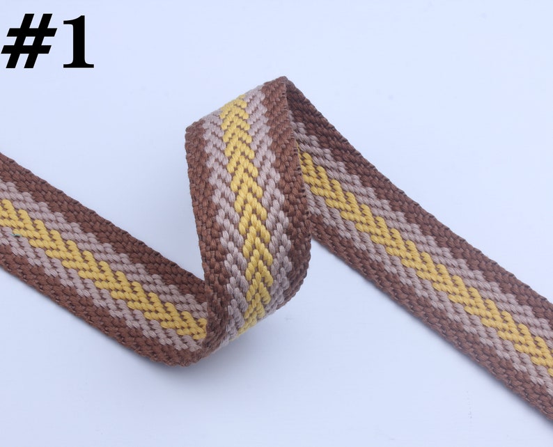 May include: Brown and yellow woven ribbon with a chevron pattern. #1