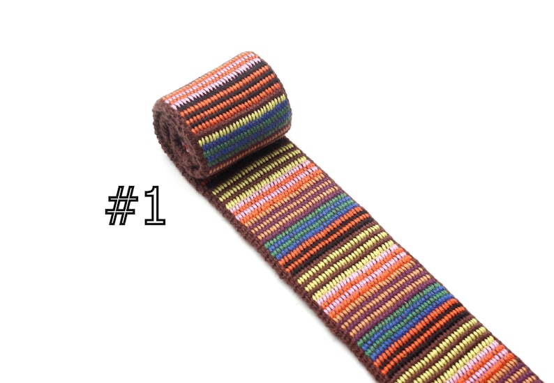 May include: Multicolored striped woven trim with brown, orange, yellow, pink, blue, and green stripes. #1