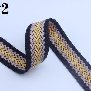 May include: Black, beige, and yellow woven webbing with a chevron pattern. #2