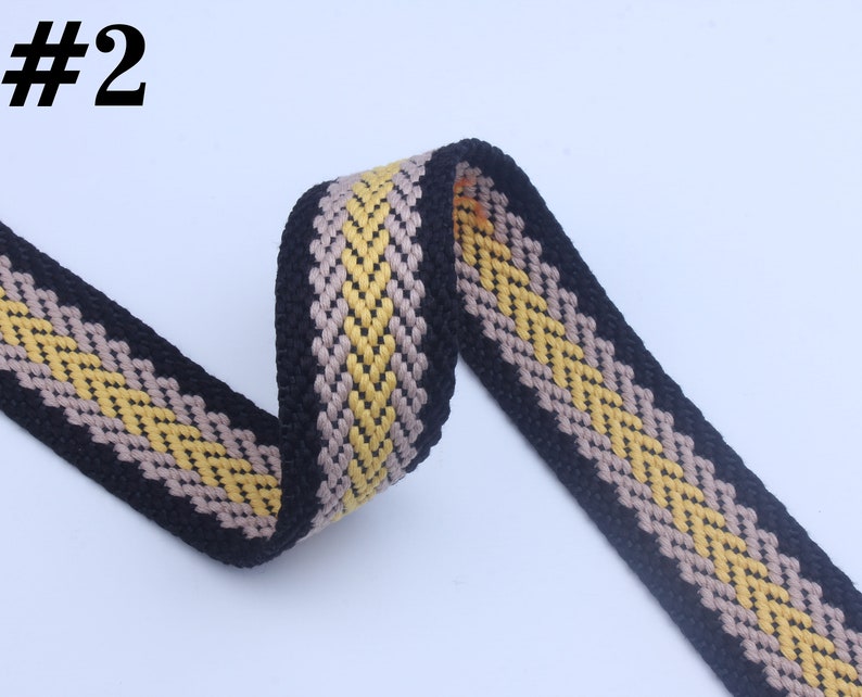 May include: Black, beige, and yellow woven webbing with a chevron pattern. #2