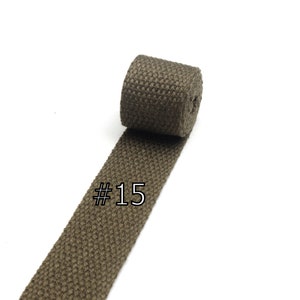 May include: A brown cotton webbing strap with a woven texture. The strap is rolled up and labeled with the number #15.