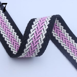 May include: Black, white, and pink woven cotton webbing with a chevron pattern. #7